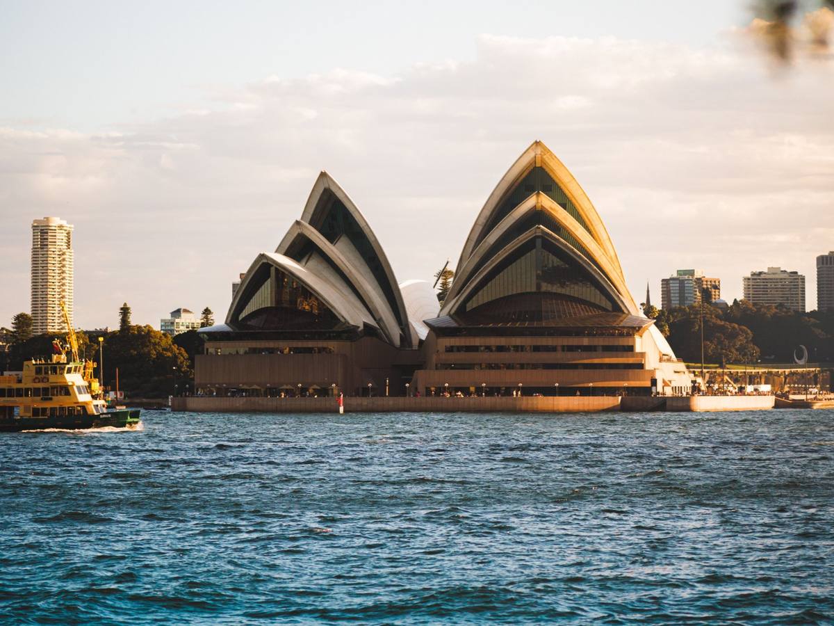 Sydney Opera House at sunset with a ferry on the harbour